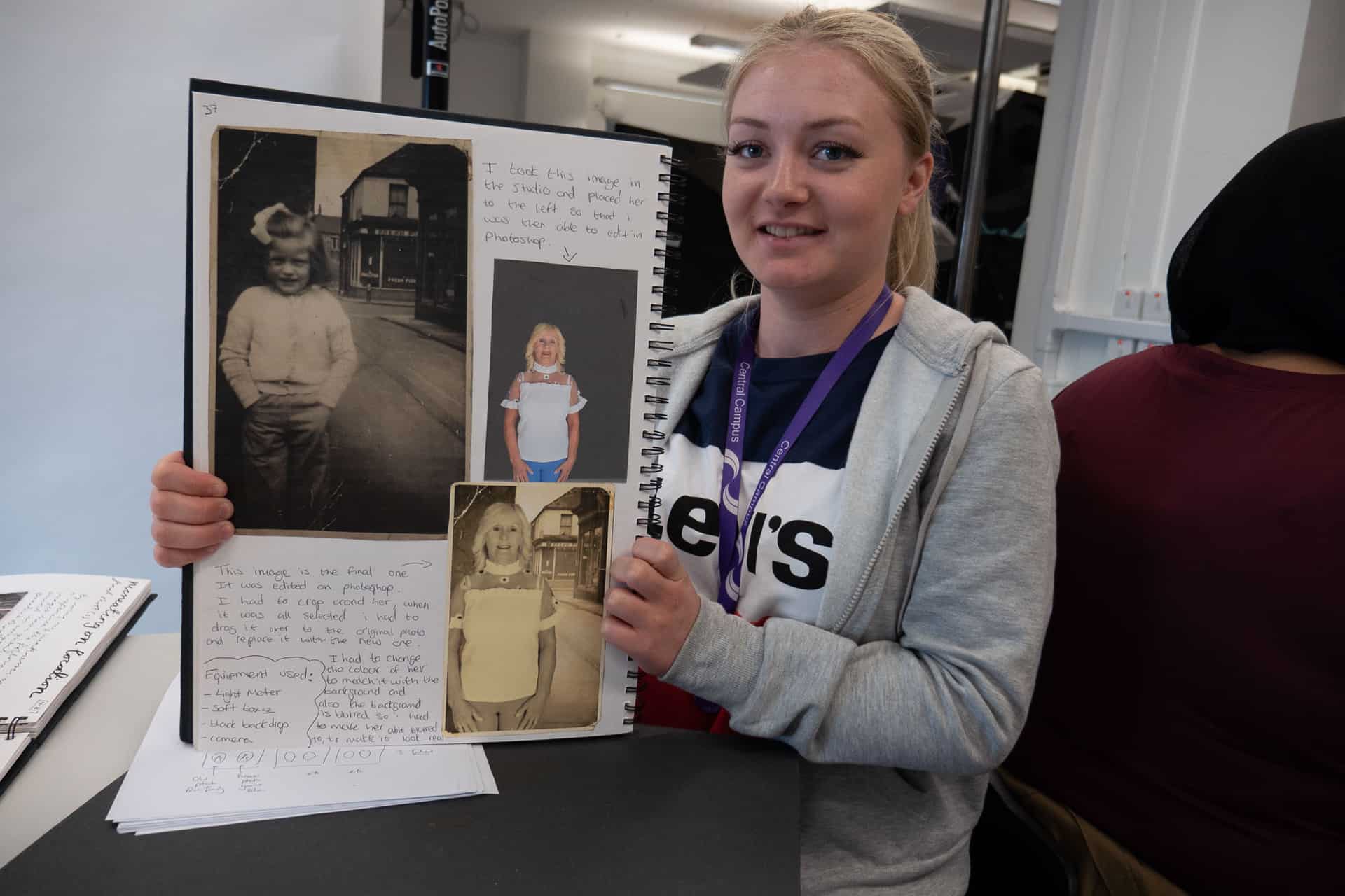 A student at Sandwell College shows off her project book featuring work made with her family collection as part of the Living Memory project 
