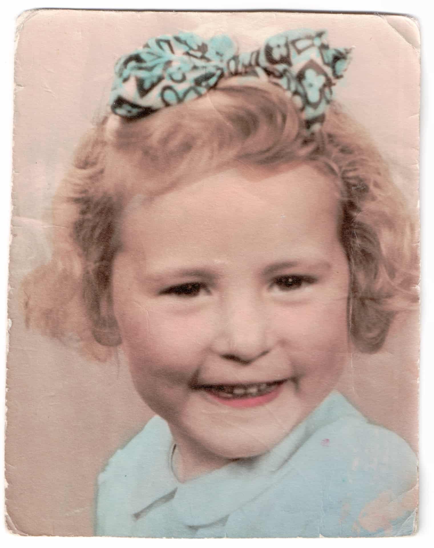 This one has been hand-tinted and was taken about the same time as the first one. I've got another one at home of me with the curly hair like that. 