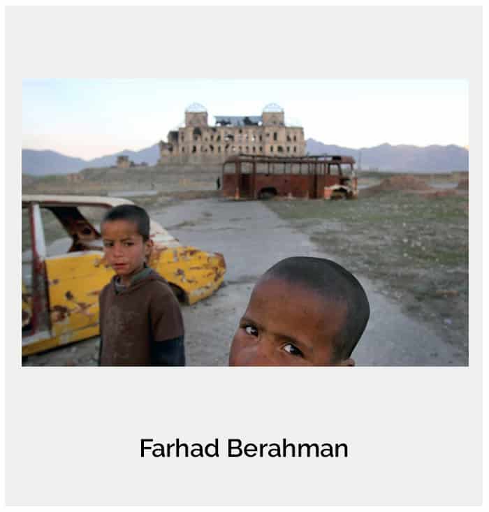 Afghan children return home past the the remains of the Darul Aman royal Palace in Kabul, Afghanistan, Tuesday April 12, 2011.