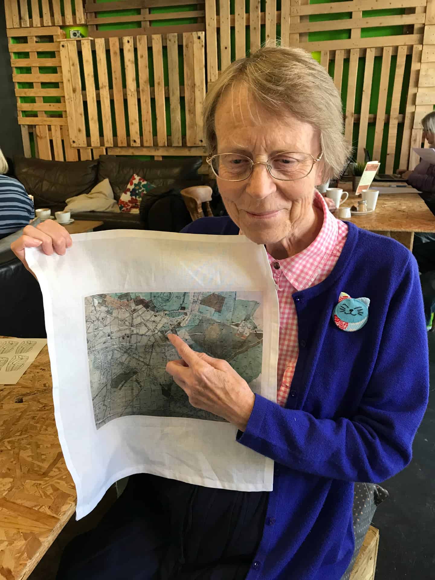 Wendy with her printed fabric showing places she remembers visiting as a child.